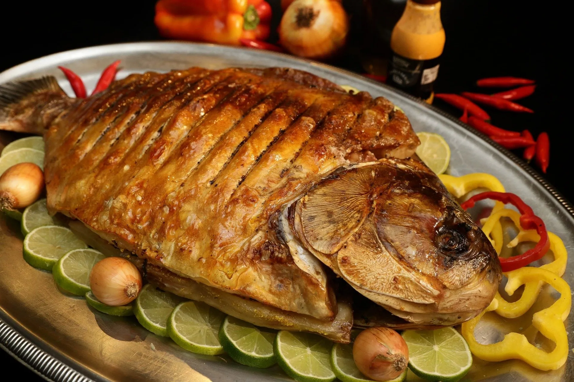 Peixe assado típico da gastronomia cuiabana servido com limão e pimentões